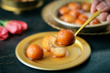 Gulab jamun gulaab jamun sugar syrup golden bowl Indian sweet food mithai Egyptian Zalabia balls serving Diwali sweets Dussehra Holi ganesh chaturthi Ram navmi Ramadan Pakistan India Sri Lanka Kerala 