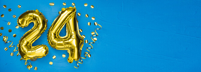 golden foil balloon number twenty four. Birthday or anniversary card with the inscription 24. blue...
