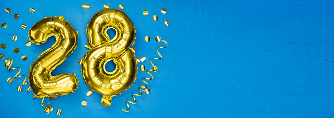 golden foil balloon number twenty eight. Birthday or anniversary card with the inscription 28. blue...