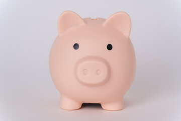 Pink piggy bank on a white background. The concept of money accumulation, financial well-being, banking security, pension savings.