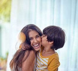 Happy is the child whos mother is happy. Shot of an adorable little boy affectionately kissing his...