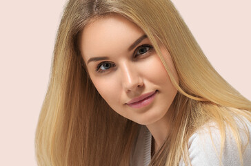 Naklejka premium Long smooth blonde hairstyle beauty woman portrait. Crossing hands. Color background pink