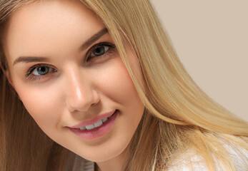 Long smooth blonde hairstyle beauty woman close up portrait. Color background brown
