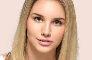 Long smooth hair beauty woman close up portrait blonde hairstyle. Color background pink