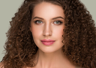Naklejka premium Curly long brunette hair woman beauty portrait, female glamour face. Color backgound green