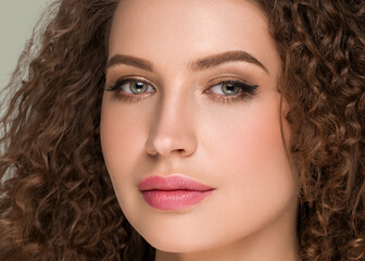 Curly long brunette hair woman beauty portrait, female glamour face. Color backgound green