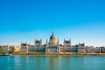 Fototapeta premium Building on the river. Beautiful view of Budapest parliament at sunset, Hungary. Great architecture
