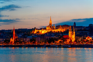 Fototapeta na wymiar Wonderful mesmerizing view of the city at night illuminated by lights on the danube river. Beautiful landscape on the parliament on the river. Wonderful architecture at night. Hungary, budapest