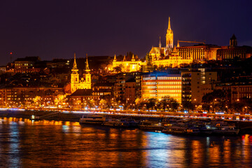 Fototapeta na wymiar Wonderful mesmerizing view of the city at night, illuminated by lights, on the danube river. Hungary, budapest. Magic architecture at night. Beautiful landscape on the parliament on the river.