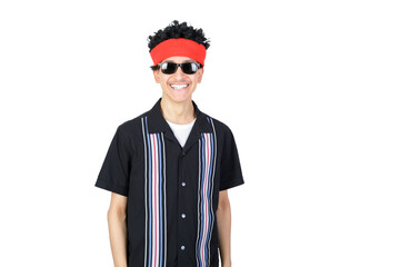 Happy guy smiling looking at camera, wearing an afro wig and sunglasses. Isolated on white background. Latin 18-20 years old guy.