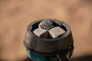 Coals for hookah close-up. Burning coals on the hookah bowl.