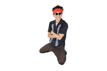 Happy jumping guy with arms crossed smiling looking at camera. Isolated on white background. Latin 18-20 years old guy.