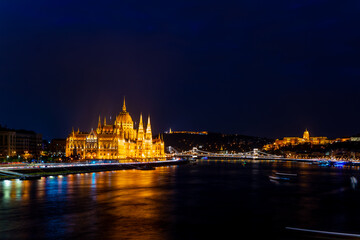 Fototapeta na wymiar Wonderful mesmerizing view of the city at night illuminated by lights on the danube river. Wonderful architecture at night. Beautiful landscape on the parliament on the river. Hungary, budapest