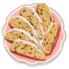 Slices of Traditional Christmas stollen cake with marzipan and dried fruit isolated on ceramic plate