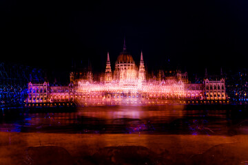 Fototapeta na wymiar A magical view of the ancient city. A beautiful old building with illumination on the banks of the danube. Hungarian parliament building at night, budapest, hungary