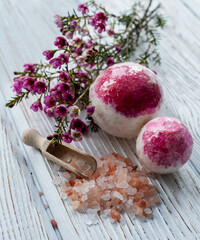 salt bomb with impurities of dried rose on a white background. handmade