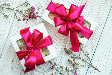 gift with a bow on a white wooden background