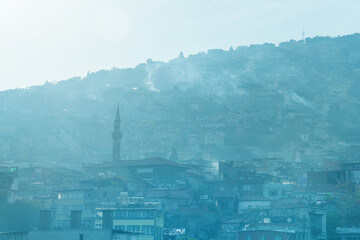 Izmir, turkey. City view with many houses on a hill in the fog. Haze