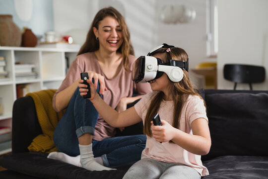 mother playing with her daughter at home. virtual world concept