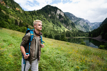 Fototapeta na wymiar Adventure man hiking wilderness mountain with backpack