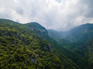 Aerial drone panoramic view of deep gorge and rocky ridge leading to legendary Mountain Olympus