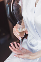 the bride in an exquisite white dress drink champagne