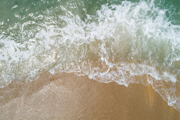 Aerial view sandy beach and waves Beautiful tropical sea in the morning summer season image by Aerial view drone shot, high angle view Top down