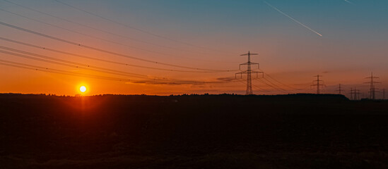 Fototapeta na wymiar Beautiful sunset with overland high voltage lines near Wallerdorf, Bavaria, Germany