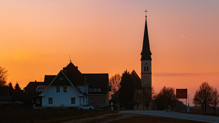 Beautiful sunset with a church silhouette near Wallerdorf, Bavaria, Germany