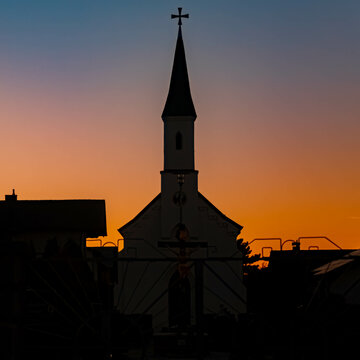 Beautiful sunset with a church silhouette at Eichendorf, Bavaria, Germany