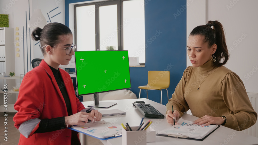 Poster business women using computer with green screen at desk. team of people talking while they work with