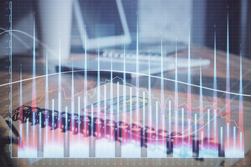 Double exposure of financial graph drawings and desk with open notebook background. Concept of forex market