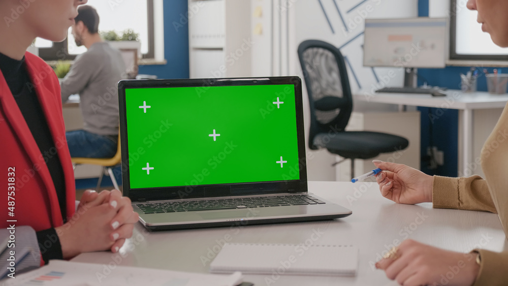 Poster close up of colleagues using laptop with green screen on desk, women working with isolated template,