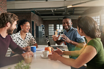 Brainstorming makes for a great team building exercise. Shot of a team of colleagues having a meeting in a modern office.