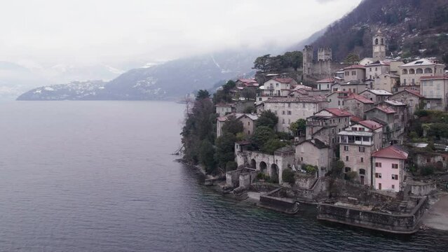 Aerial winter parallax view of Corenno Plinio village on Lake Como.