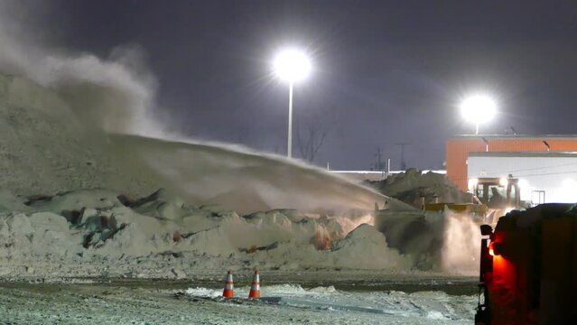 Snowblower Scraping And Piling Snow Onto Snow Dump In Montreal, Canada At Night. wide