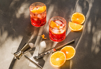 Aperitif red cocktail Campari with orange and ice copy space for text grey background.