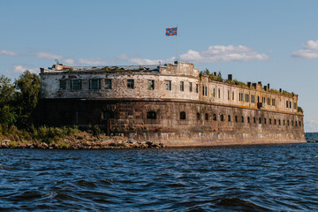 View from the water of the oldest fort Kronshlot and the lower sash lighthouse in the waters of the Gulf of Finland in Kronstadt,crown castle,defensive fortress