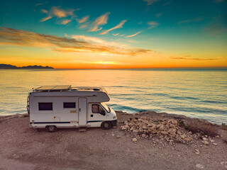 Caravan on sea coast at sunrise. Aerial view