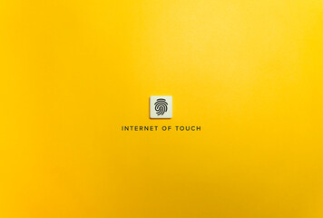 Internet of Touch Banner. Fingerprint on Letter Tile on Yellow Background. Minimal Aesthetics.