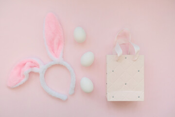 Pink bag, bunny headband and willow branches on a pink background.The concept of Easter, shopping for Easter. 