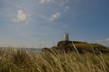 Old lighthouse Anglesey with grass foreground during summer