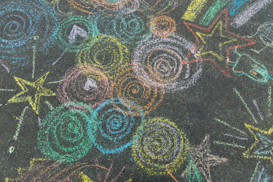 colored chalk rainbow circles drawing on the asphalt. High-quality photo
