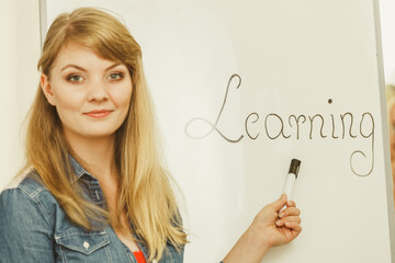 Obraz premium Student girl writting Learning word on whiteboard