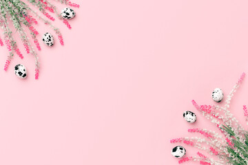 Easter composition. Easter eggs, flowers, paper blank on pastel pink background. Flat lay, top view, copy space.