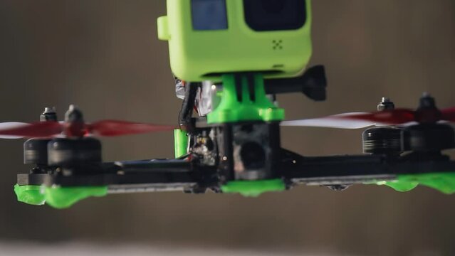 A super-large plan of a quadrocopter flying in the air. Very cool shot in motion