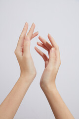 Hand model with a white background for cosmetic holding advertising , front view