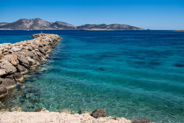 Stone breakwater with a small beacon. Koufonisia Cyclades island, Greece
