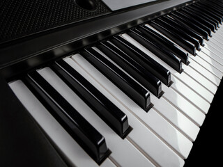 Piano keyboard. Music background.  Play piano. Synthesizer on a dark background with a gradient....