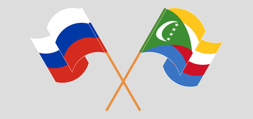 Crossed and waving flags of Russia and Comoros